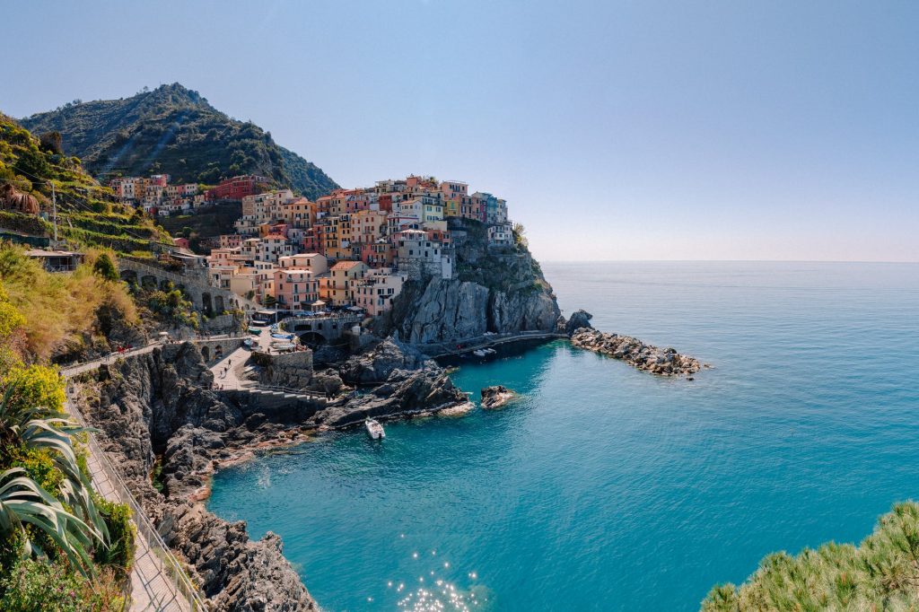 picturesque colorful village on hill on rocky seashore