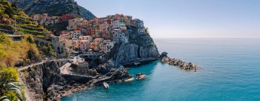 picturesque colorful village on hill on rocky seashore